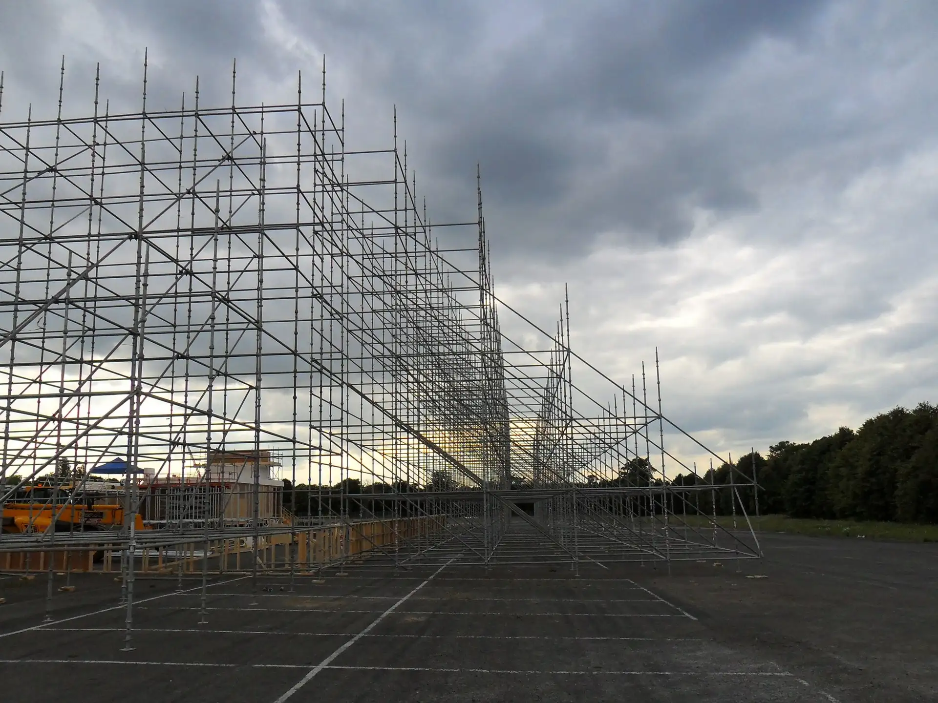 Tall free-standing scaffold frame on an open tarmac site in Aldershot, built for a film set