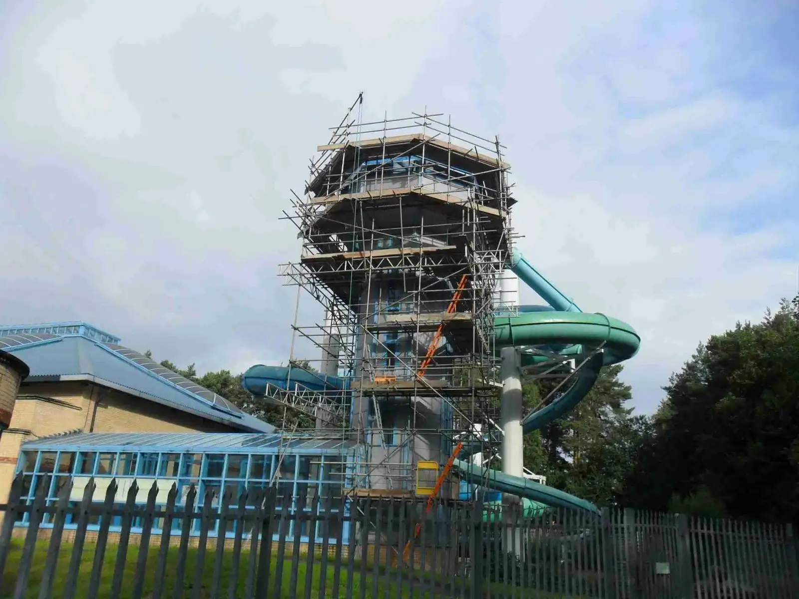 Scaffolded flume tower at Coral Reef Waterworld, Bracknell, beside the glazed pool hall