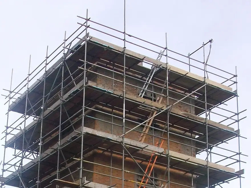 Top lifts of the scaffold on a Newbury church tower, with guardrails above the parapet