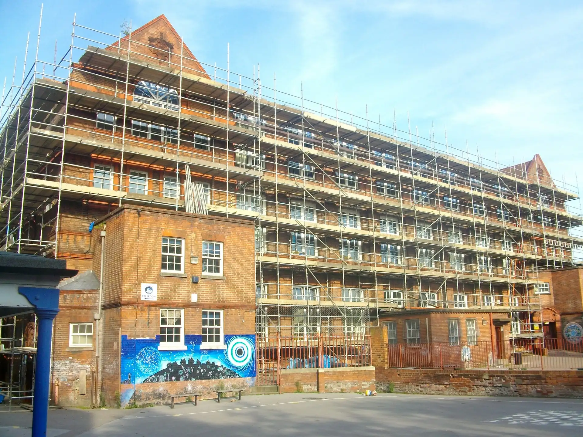 Scaffolding along a red-brick Victorian school building in Camberley for window works