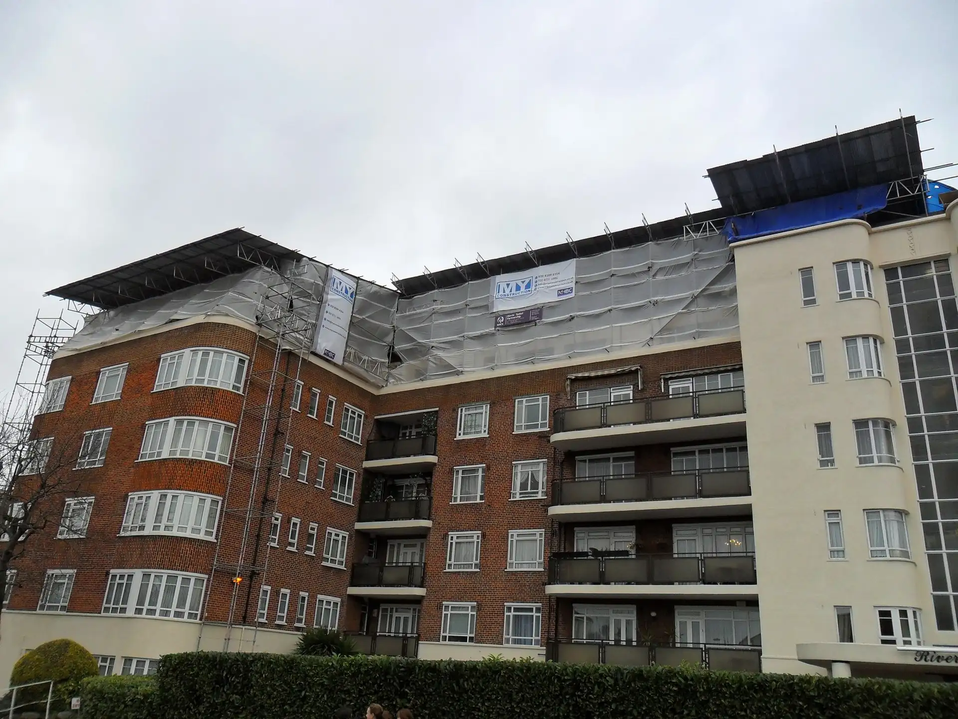 Temporary roof scaffolding over an apartment building in High Wycombe during a roof extension